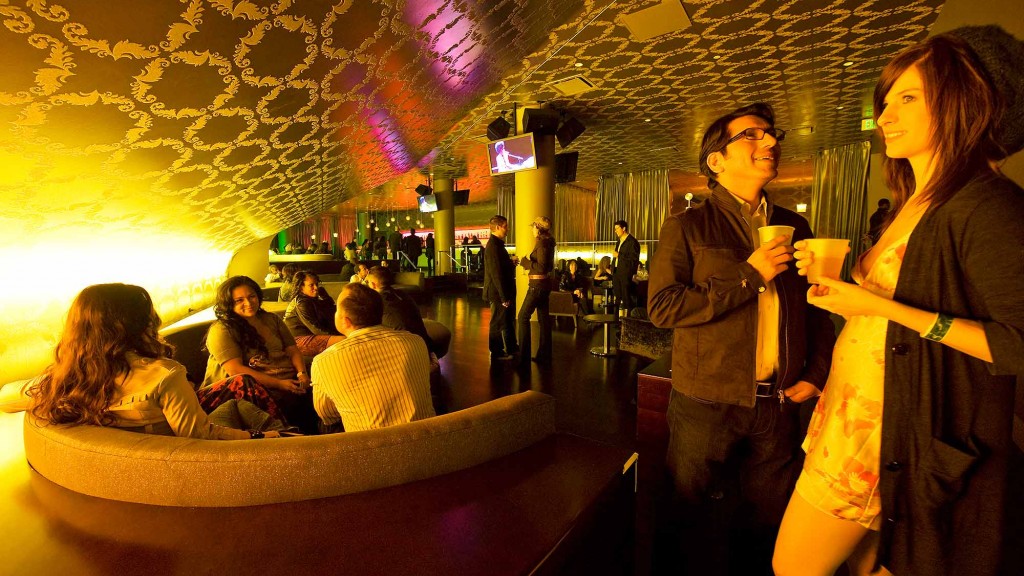 A man and woman holding drinks.