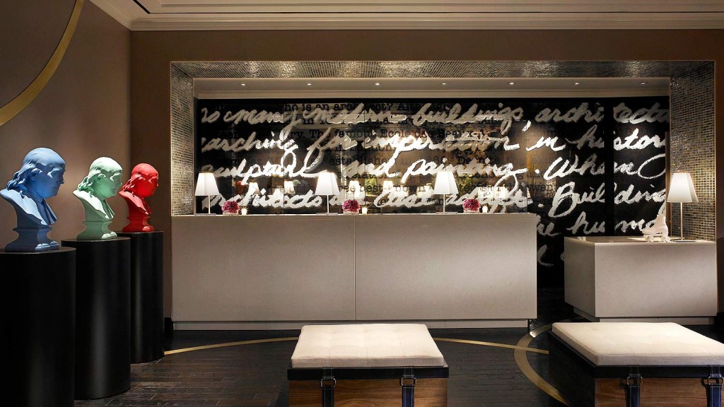 A room with a large window and a group of people in clothing.