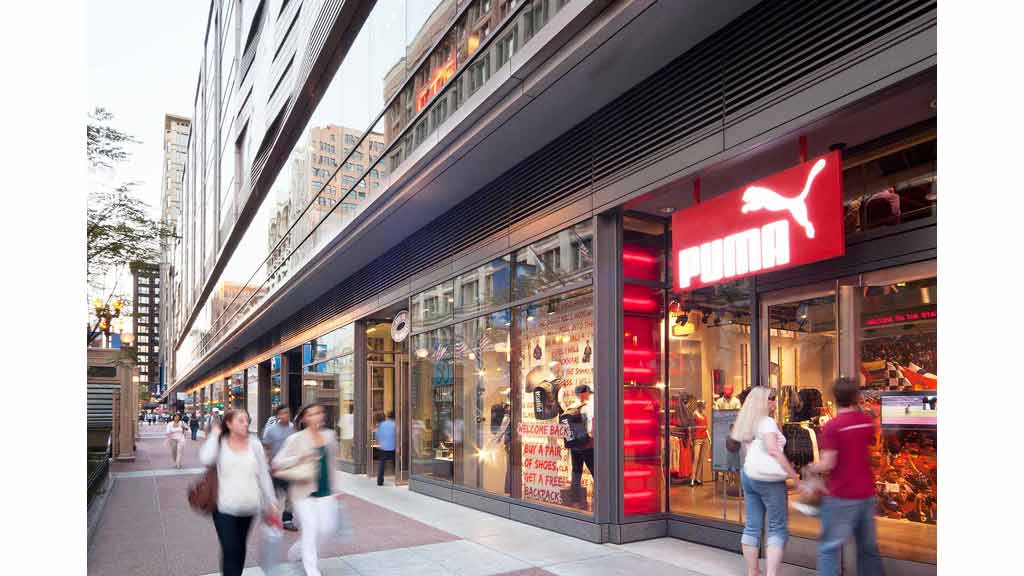 People walking past a store.