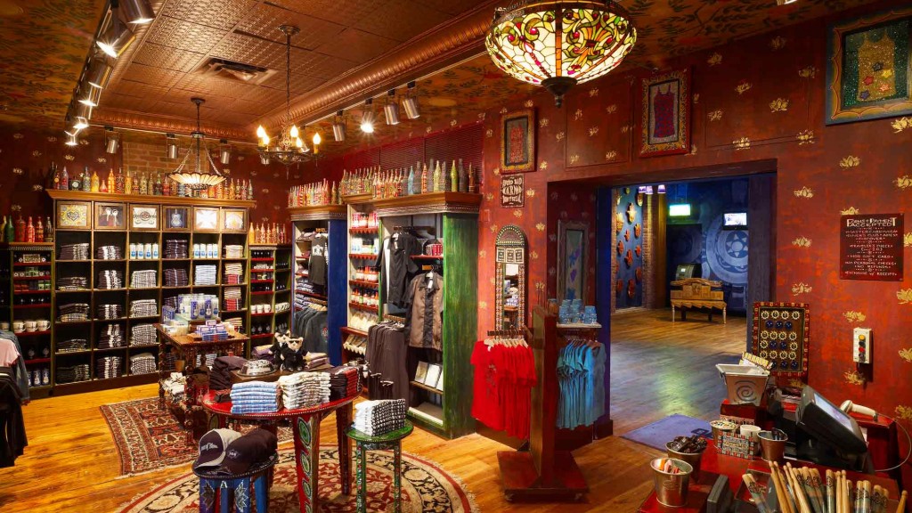 A room with a table and chairs and a chandelier.