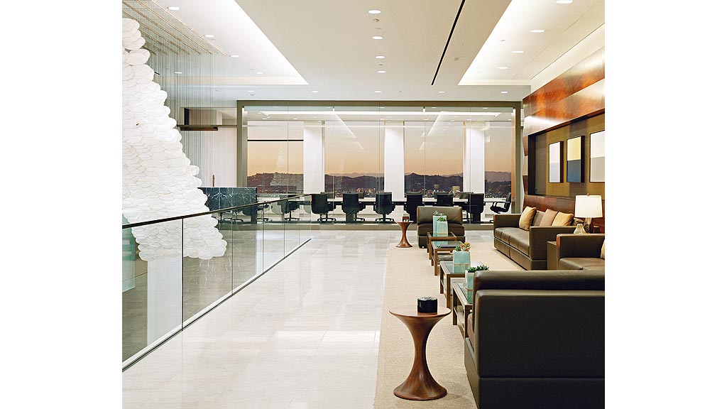 A room with a glass floor and a large glass wall with a person standing in it.