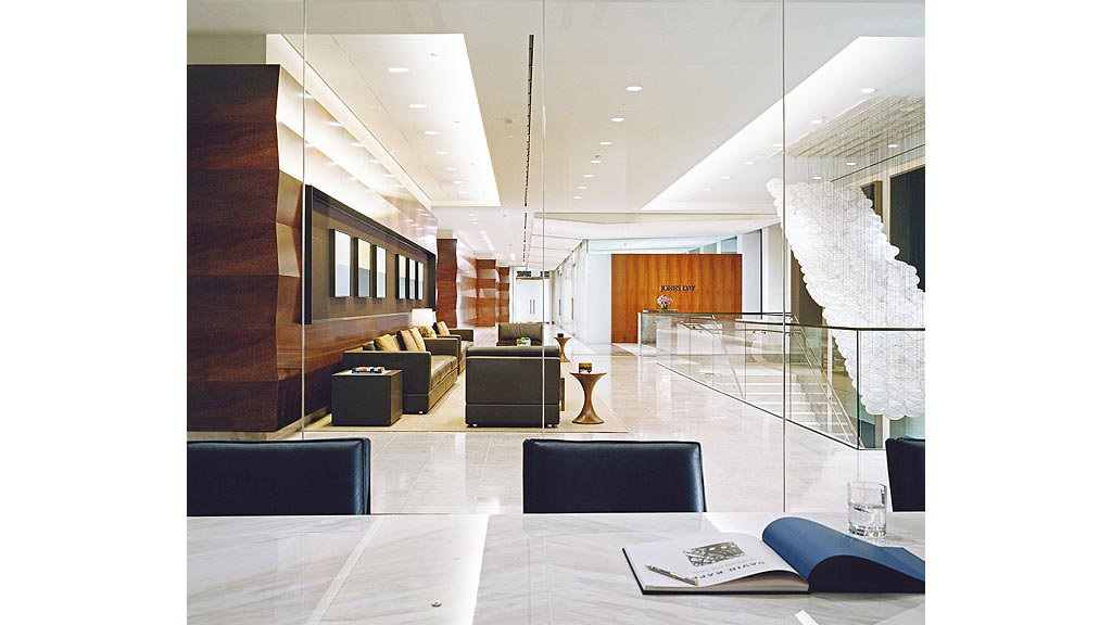 A room with a glass wall and a table with chairs and a large window.