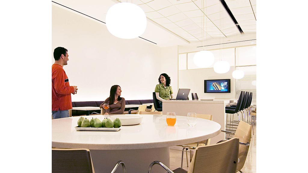 A group of people sitting at a table with food and drinks.