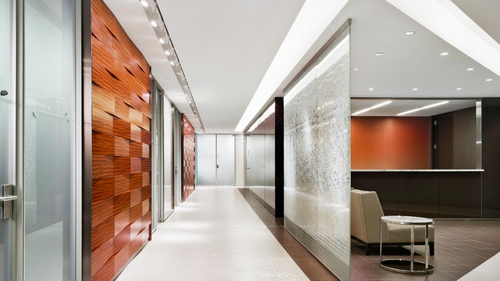 A long hallway with a chair and a table.