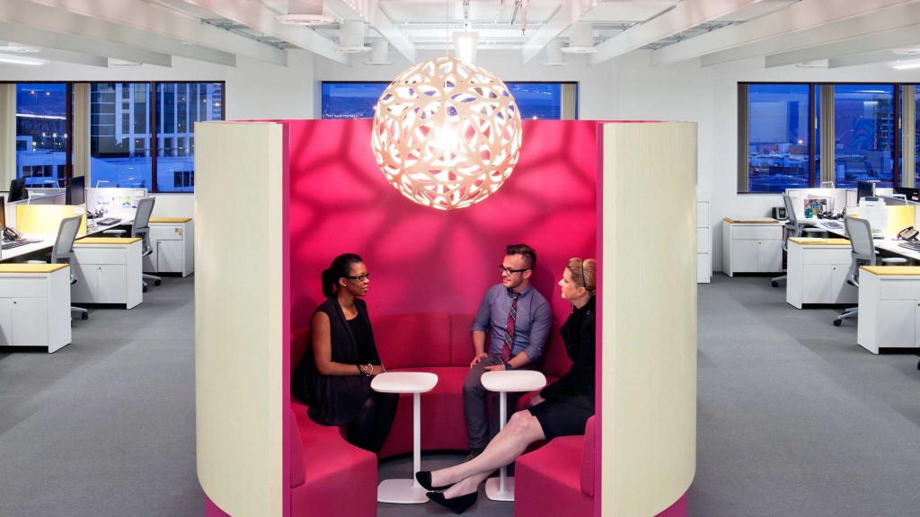 A group of people sitting in an office.