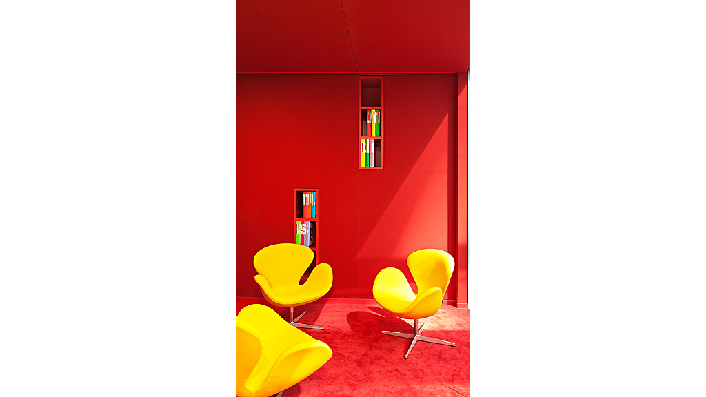 A room with chairs and a window.