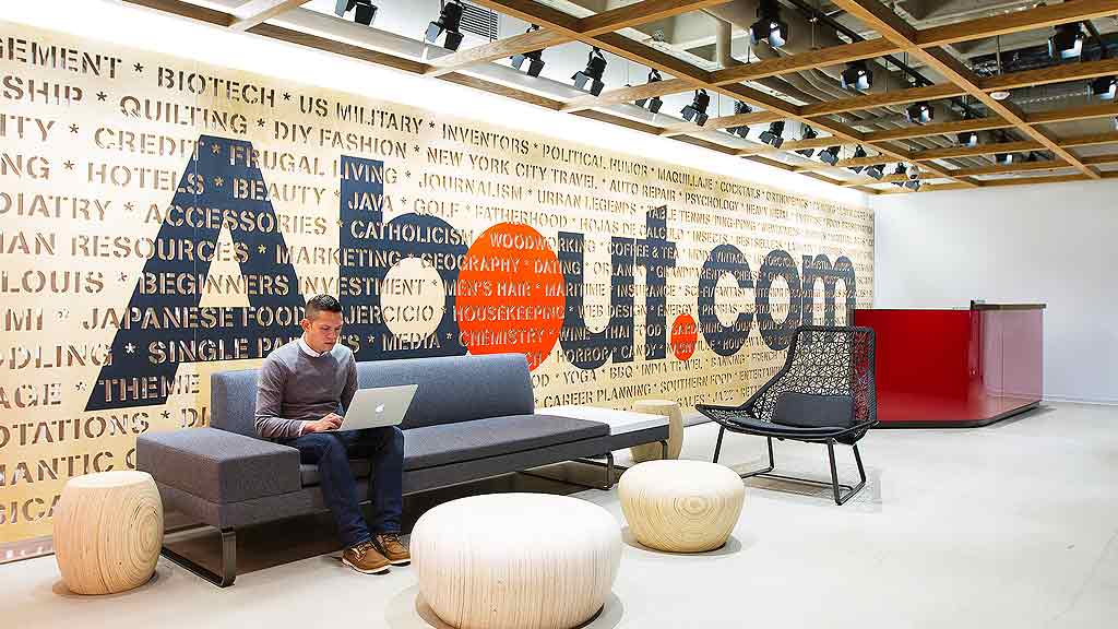 A person sitting on a couch with a laptop.