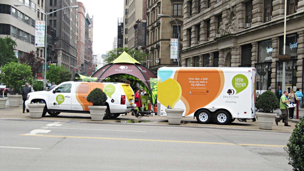 A truck with a large balloon on top of it.