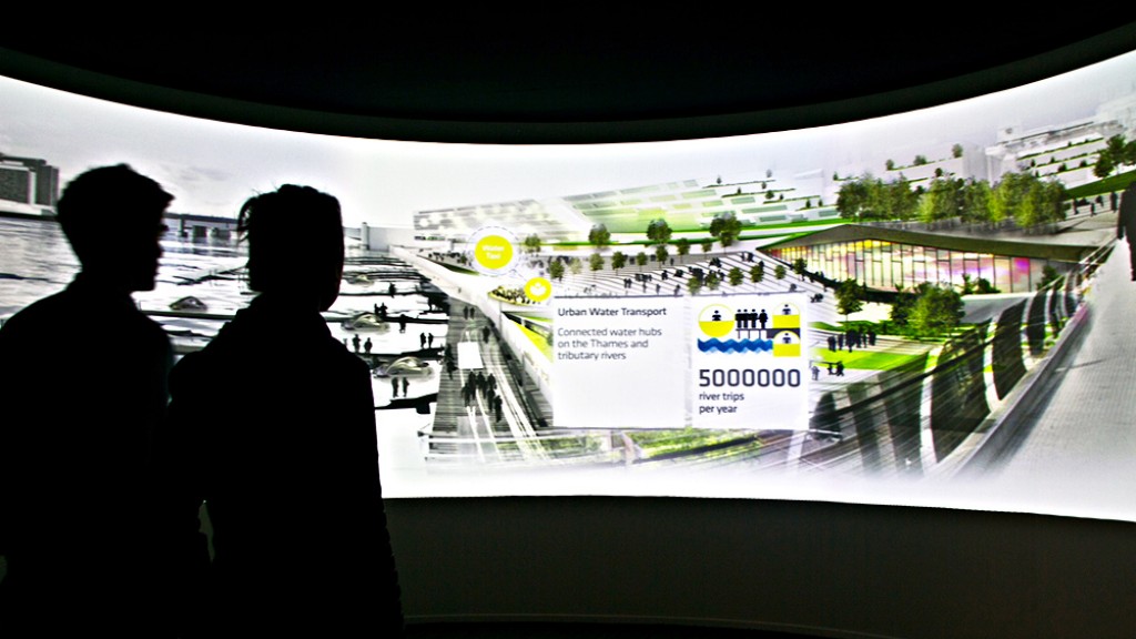 People looking at a large screen.