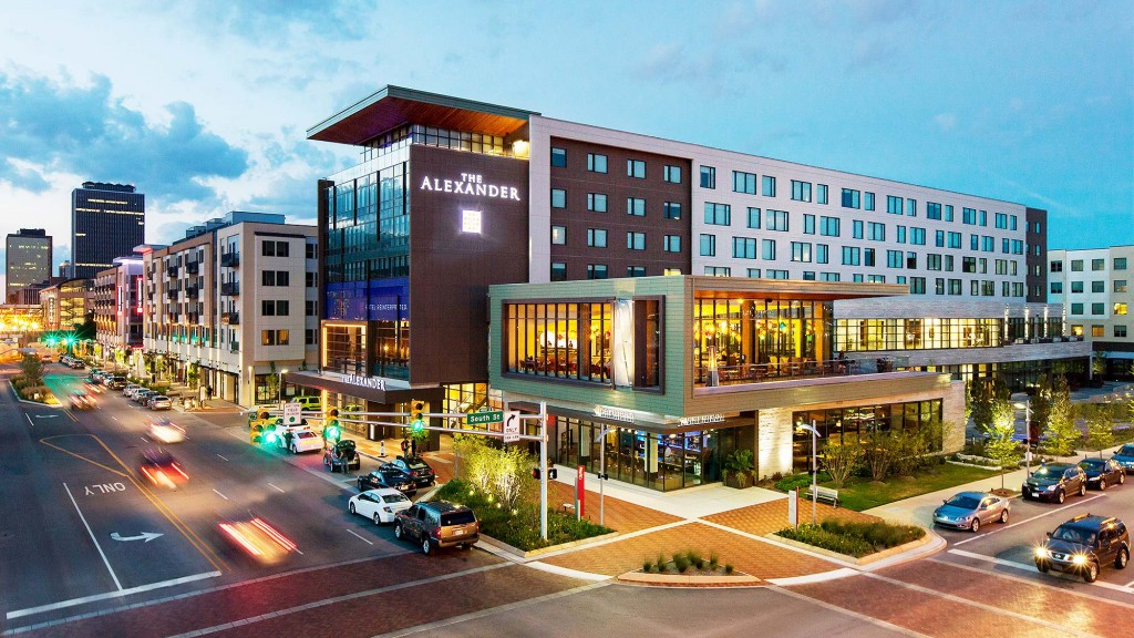 A street with cars and buildings on the side.