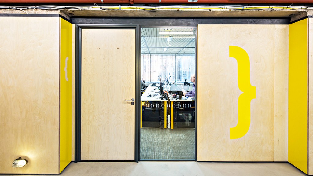 A yellow building with a glass door.