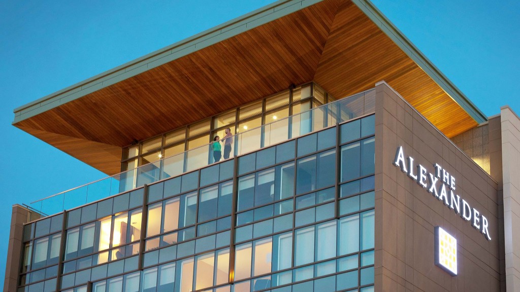 A building with windows and people standing on the roof.