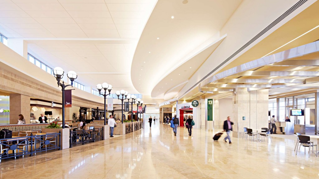 A large open area with people and tables and chairs.