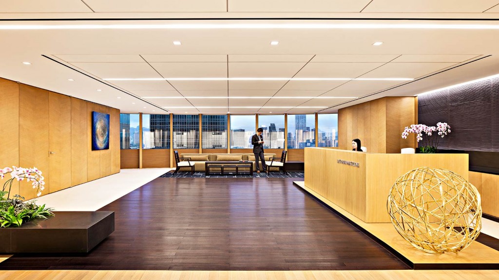 A large room with a large glass wall and a large round table.