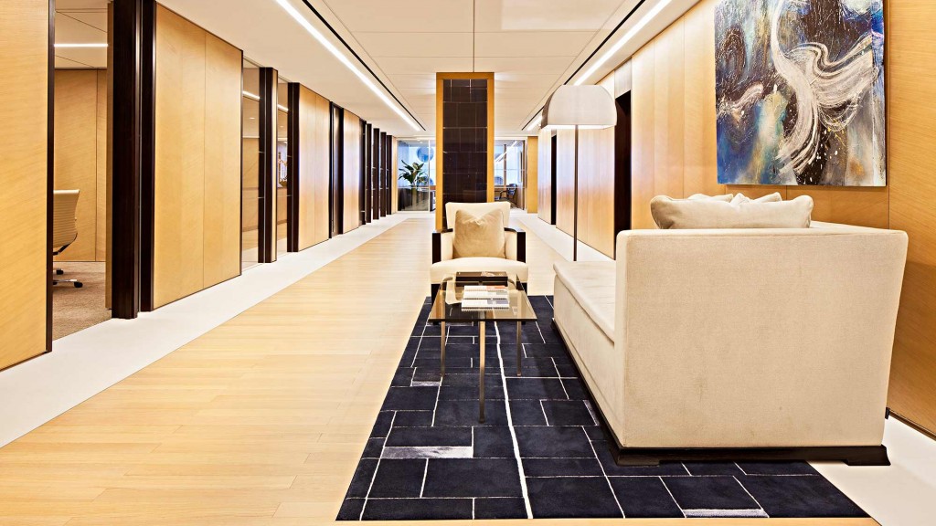 A room with a couch and a rug.