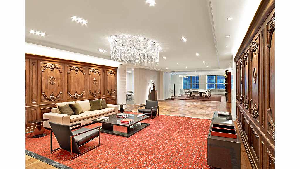 A living room with a red carpet.