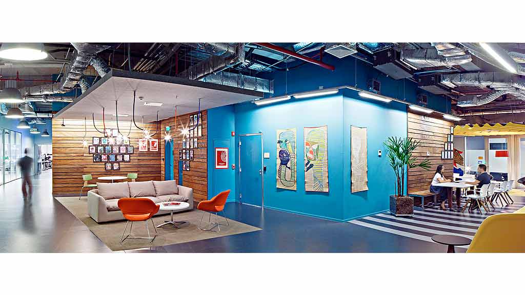 A room with a couch and chairs.