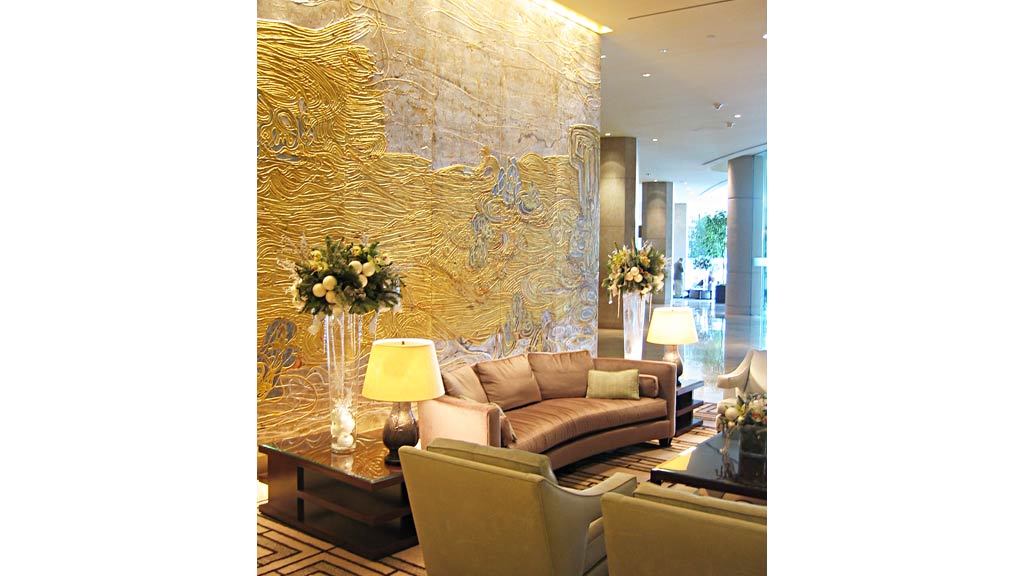A living room with a large gold bird sculpture.