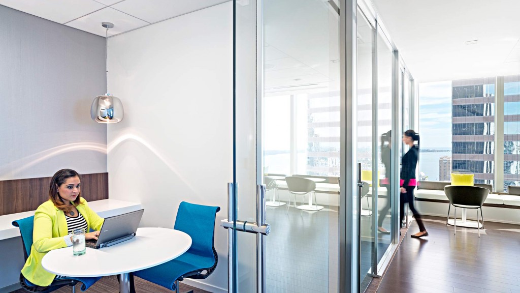 A person sitting at a table with a laptop.