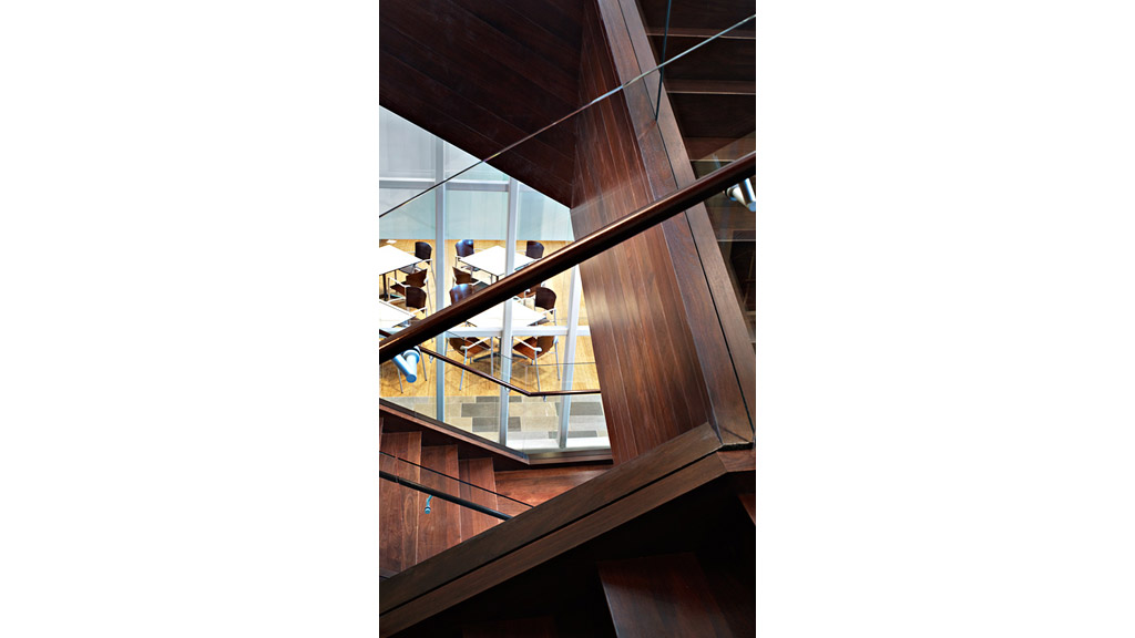 A staircase with glass railings.