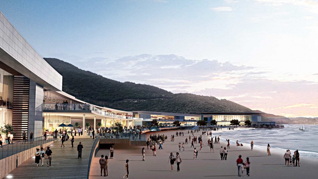 A group of people walking along a beach.