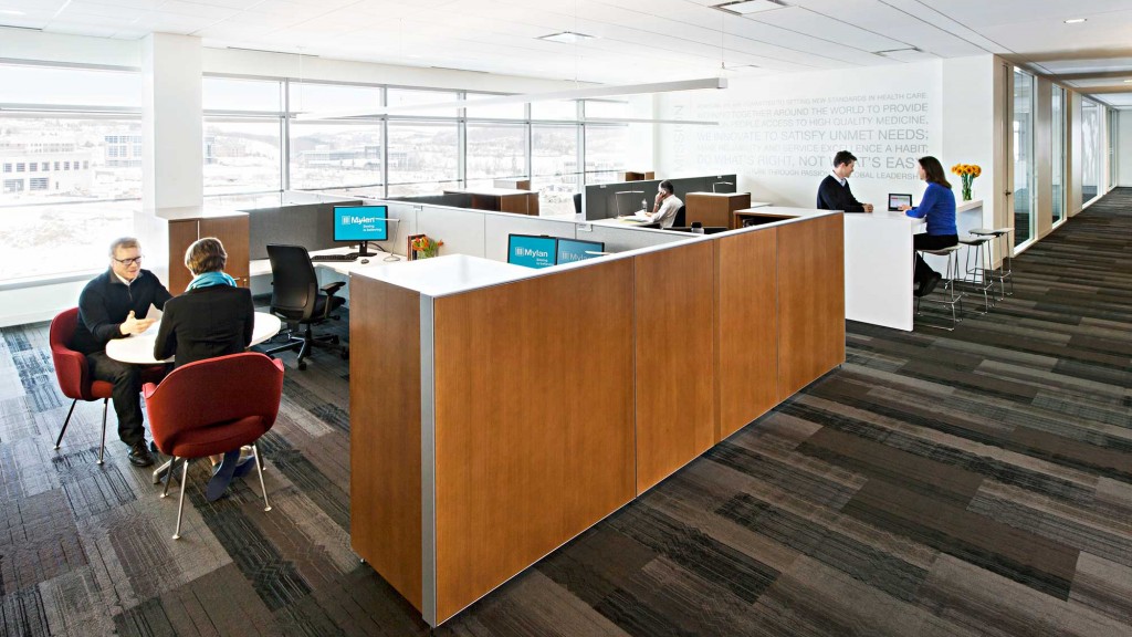 A group of people sitting at a table in a room with a large window.