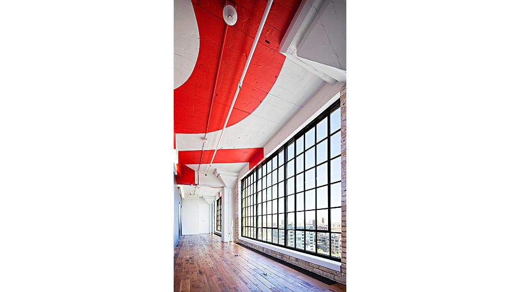 A red and white building with a black gate.