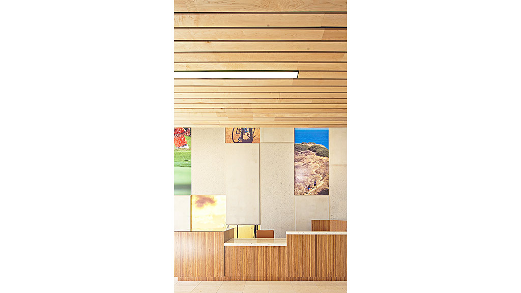 A room with a wood wall and art on the wall.