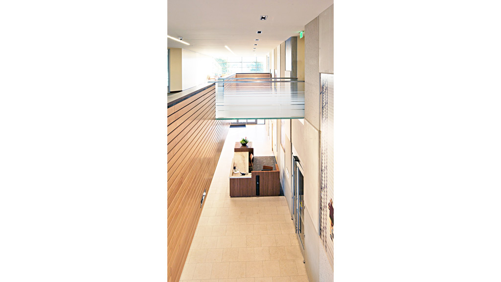 A long hallway with a wood floor.