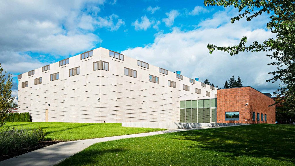 A building with a green lawn.