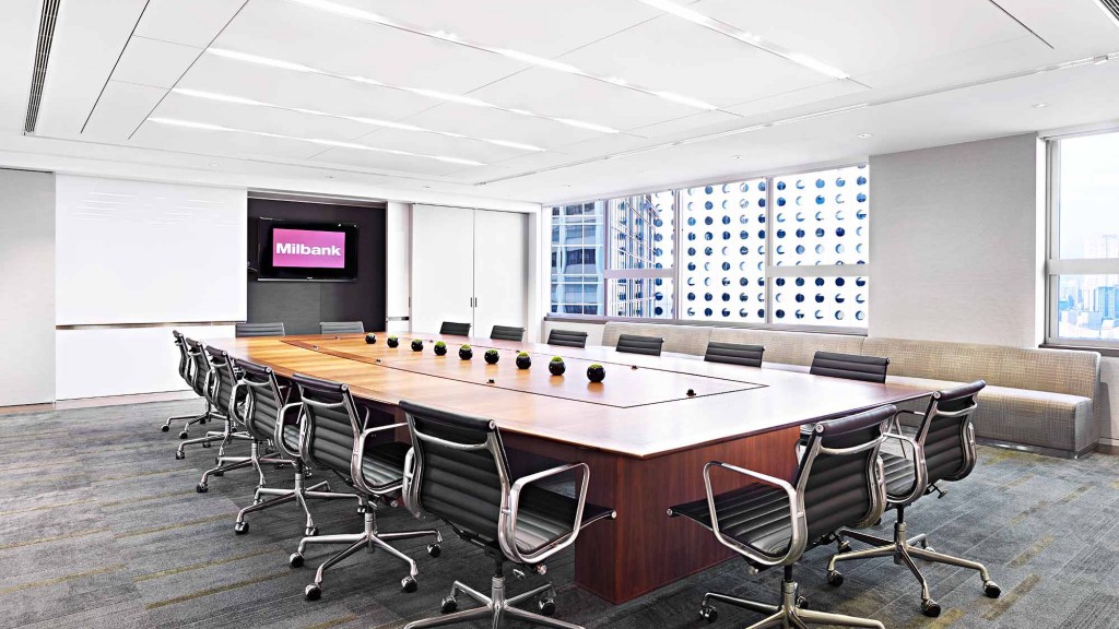 A conference room with a large table and chairs.