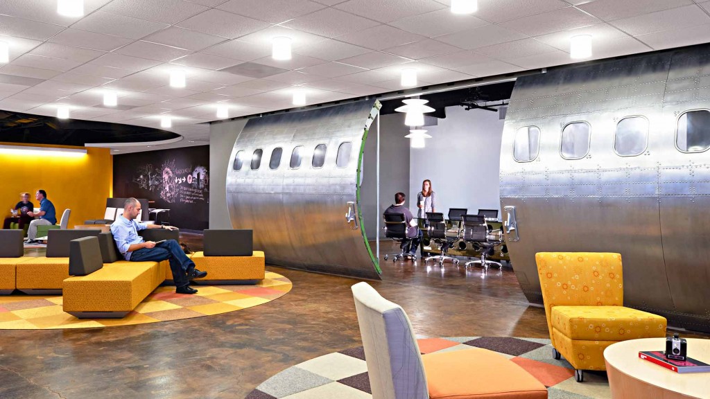 A room with chairs and people.