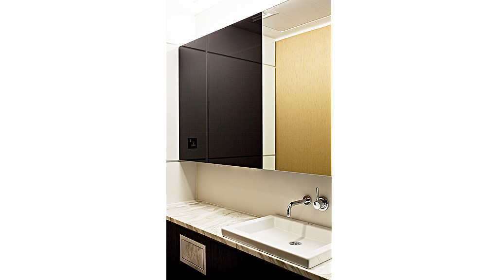 A bathroom with a sink and a mirror.