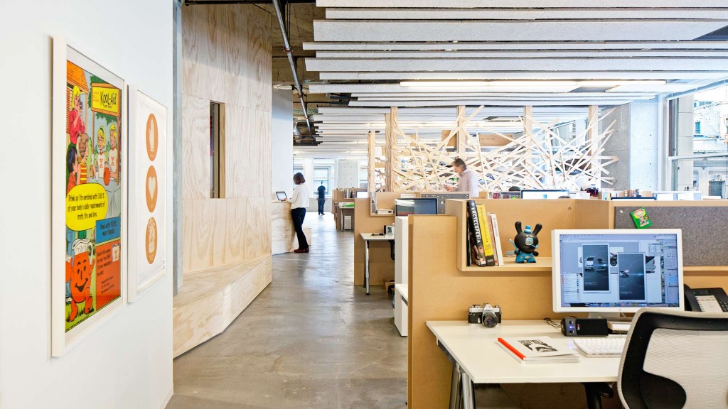 A long hallway with computers and people.
