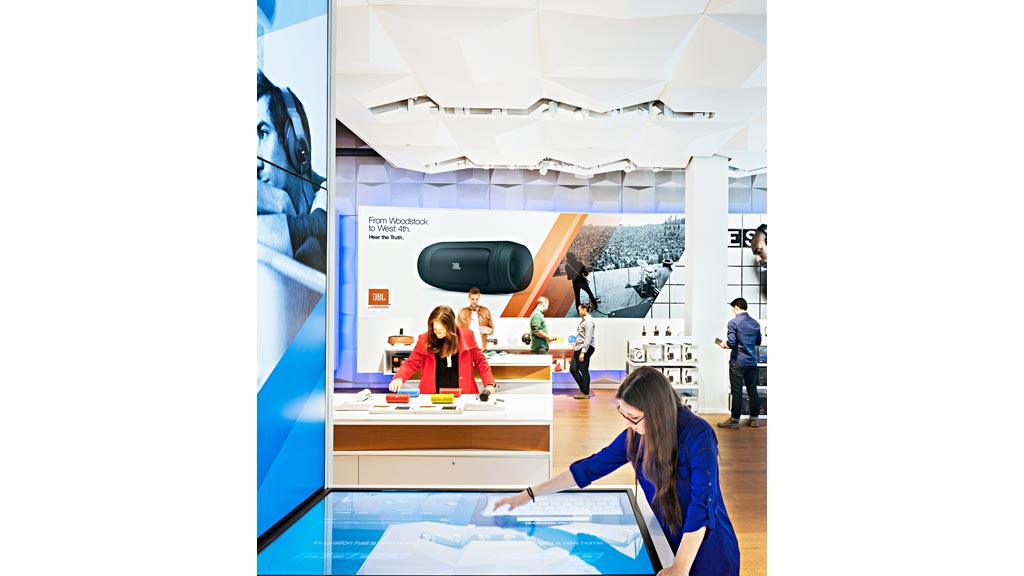 A person pointing to a large screen.