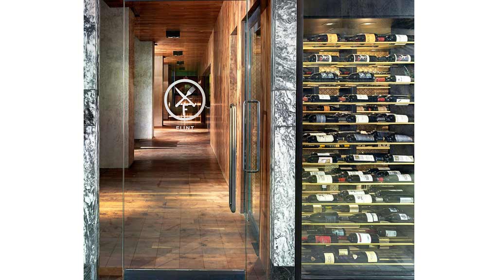 A room with a large display of books.