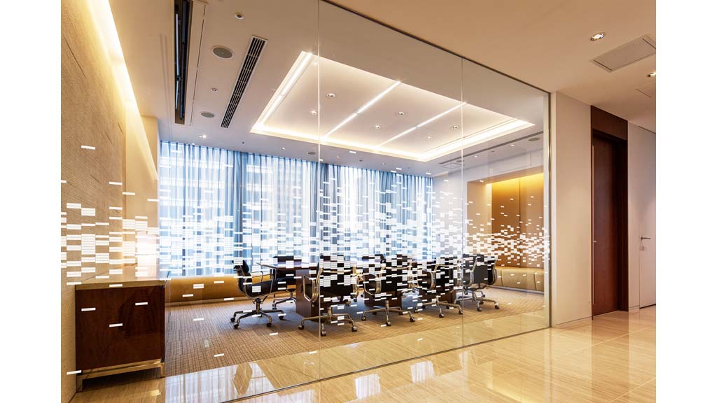 A room with a large window and chairs.