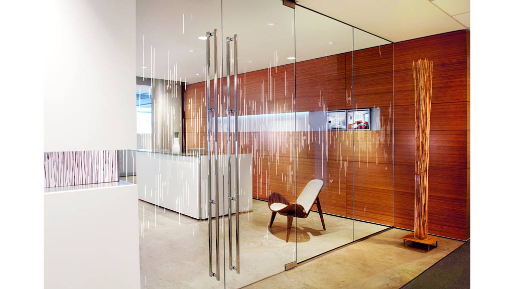A room with a glass wall and a chair.