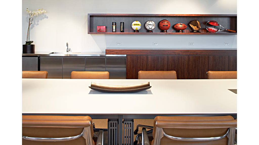 A kitchen with a table and chairs.
