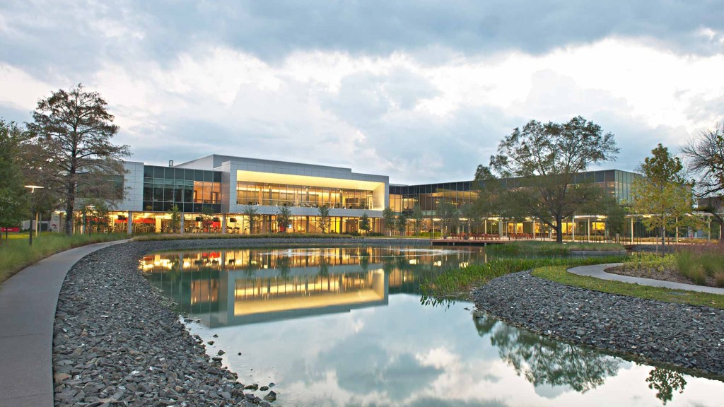 A building with a pond in front of it.