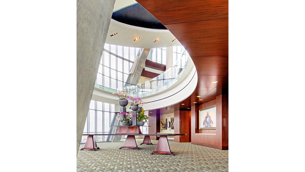 A room with a large window and a rug in it.