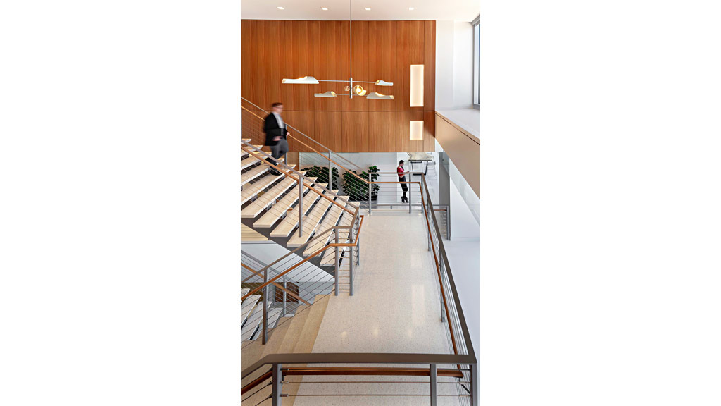 A couple of people walking up a flight of stairs.