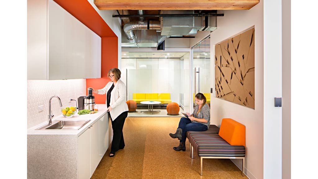 A woman and a man in a kitchen.