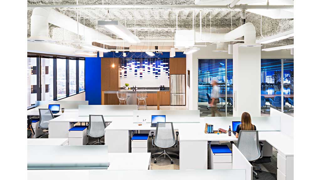 A room with a large screen and chairs.