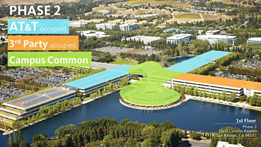 A large building with a pool in front of it.