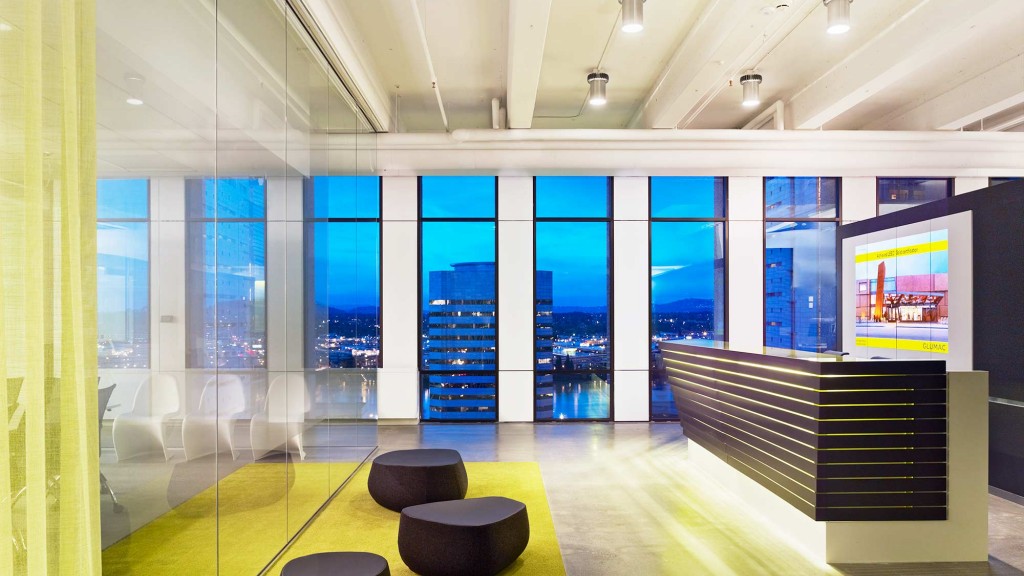 A room with a large screen and chairs.