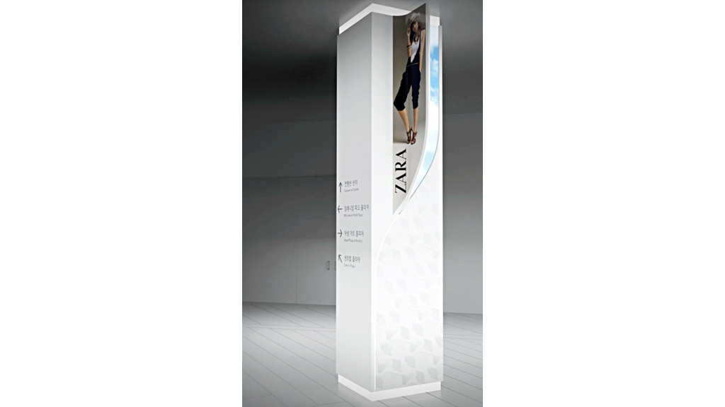 A person standing on a white pillar.