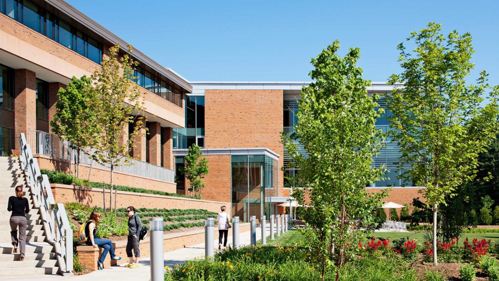 A group of people walking outside of a building.