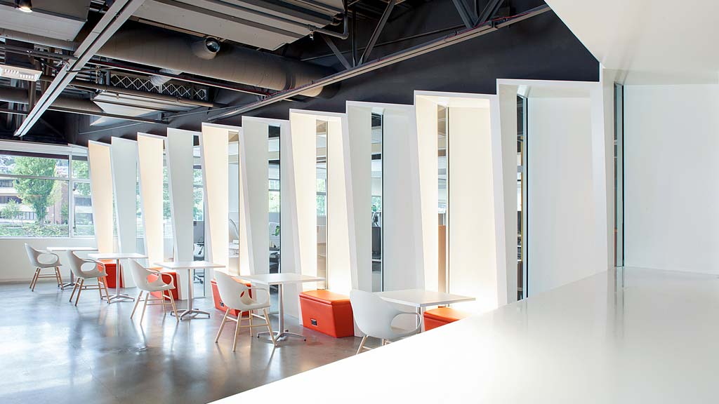 A room with white walls and red chairs.