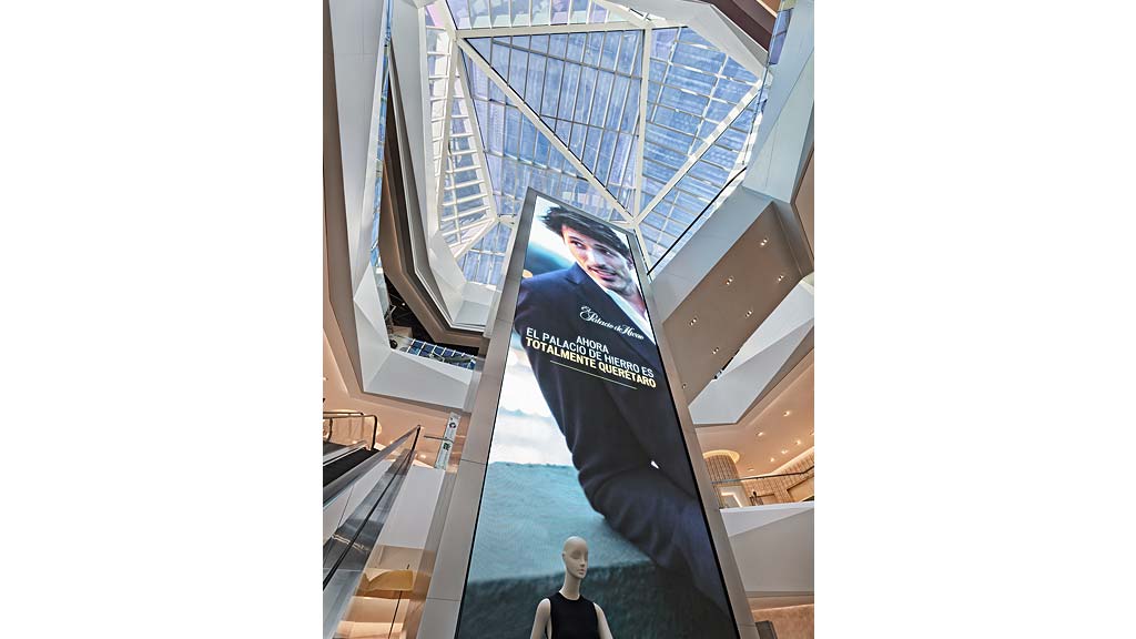 A person standing in front of a large poster.
